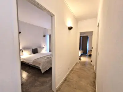 a bedroom with a bed and a large mirror at Airy 3br, AC, Garden, 2min Strip, 8min Oura Beach in Albufeira