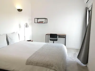 a bedroom with a bed and a desk and a chair at Airy 3br, AC, Garden, 2min Strip, 8min Oura Beach in Albufeira