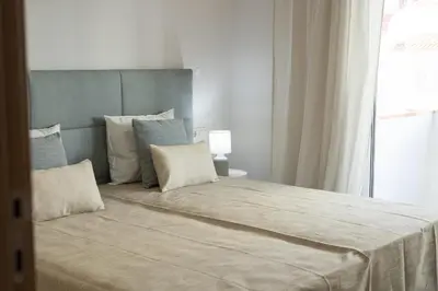 a bedroom with a large bed and a window at Miral 5 Sea front by HD Properties in Quarteira