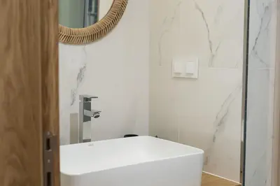 a bathroom with a white sink and a mirror at Miral 5 Sea front by HD Properties in Quarteira