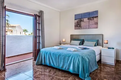 a bedroom with a bed and a large window at Villa Mar Gale in Galé