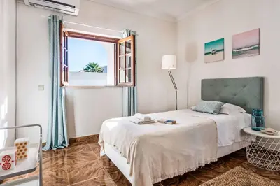 a white bedroom with a bed and a window at Villa Mar Gale in Galé
