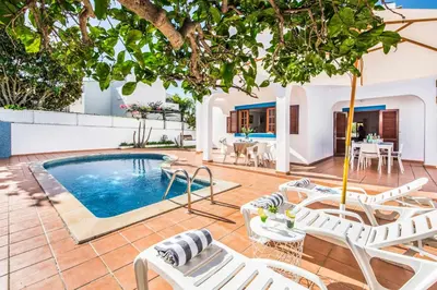 a villa with a swimming pool and lounge chairs at Villa Mar Gale in Galé