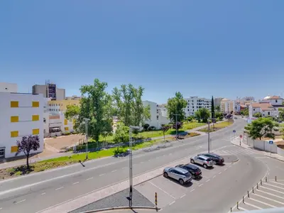 a street with cars parked on the side of a road at AL - Vilamoura Algardia in Vilamoura