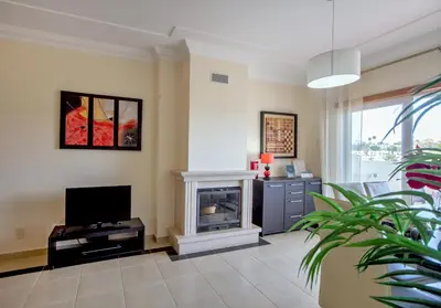 a living room with a fireplace and a television at Villa Albufeira by Atlantic Places in Albufeira