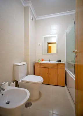 a bathroom with a toilet and a sink and a mirror at Villa Albufeira by Atlantic Places in Albufeira