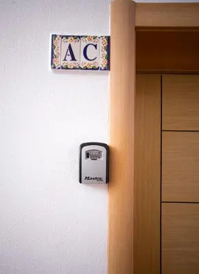 a door with aania sign on the wall next to a cabinet at Villa Albufeira by Atlantic Places in Albufeira