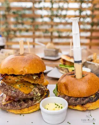 a hamburger with a knife on top of it at Villa Albufeira by Atlantic Places in Albufeira