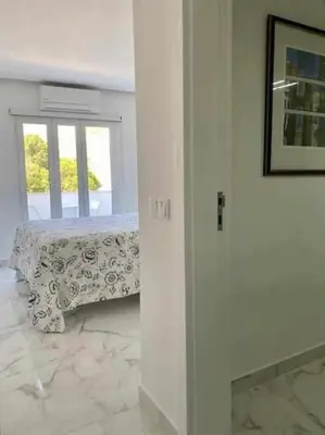 a white room with a table and a window at Downtown Art Flat in Albufeira