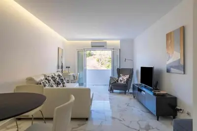 a living room with a couch and a tv at Downtown Art Flat in Albufeira