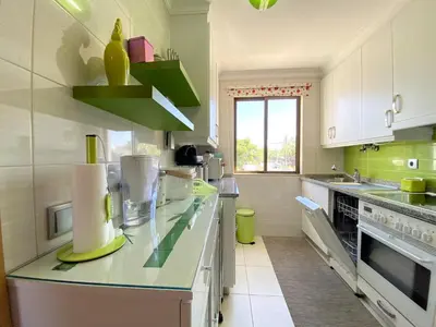 a kitchen with white cabinets and a green counter top at Vilamoura Central 7 With Pool by Homing in Vilamoura