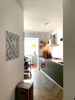 a bedroom with a large bed with a large white headboard at Loulé Old Town Apartment in Loulé