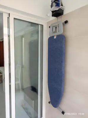 a skateboard hanging on a wall next to a glass door at The Retreat - O Retiro Algarvio in Faro