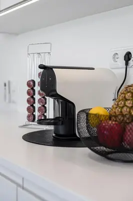a coffee maker on a counter with fruit in a basket at The Albufeira Concierge - Prime Lounge Design in Albufeira