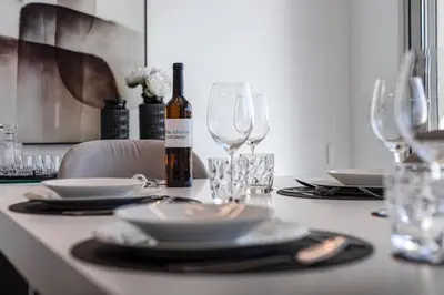 a table with a bottle of wine and glasses on it at The Albufeira Concierge - Prime Lounge Design in Albufeira