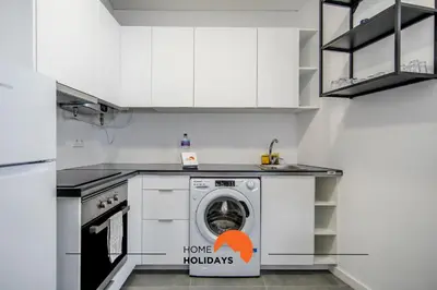 a kitchen with a washing machine in the middle at #163 Dr José Silva 17 by Home Holidays in Albufeira