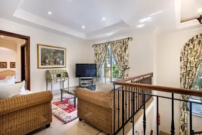 a living room with a couch and a television at Villa Plaza - beautiful spacious house off roundabout 6 Quinta Do Lago in Quinta do Lago