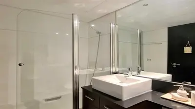a bathroom with a sink and a glass shower at Vila Mitri, Monte laguna-CleverDetails, 5 bedroom villa, sleeps 8 adults 2 children in Vilamoura