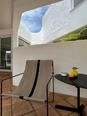 a chair and a table in a living room at Casa di Campara Villa Faro in Faro