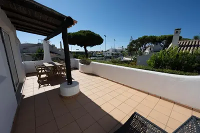 a balcony of a house with a table and chairs at Casa di Campara Villa Faro in Faro