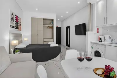 a living room with two wine glasses on a table at Estudio Balaia by Villas Key in Albufeira