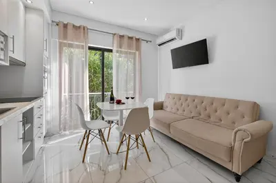 a living room with a couch and a table at Estudio Balaia by Villas Key in Albufeira