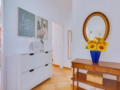 a room with a dresser and a mirror and a table at AL - Apartamento Quinta do Romão in Quarteira