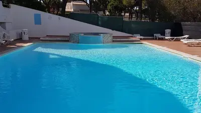 a large swimming pool with blue water at Pine Trees Penthouse in Olhos de Água