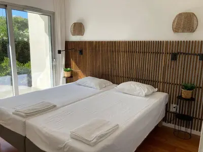 a bedroom with a bed with white sheets and a window at The Albufeira Concierge - Amazing Pool & Sunshine in Albufeira