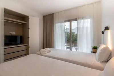 a bedroom with a large bed and a window at The Albufeira Concierge - Amazing Pool & Sunshine in Albufeira