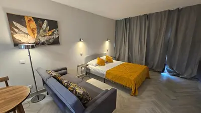 a hotel room with a bed and a couch at Ocean View Beach Studio Old Town in Albufeira