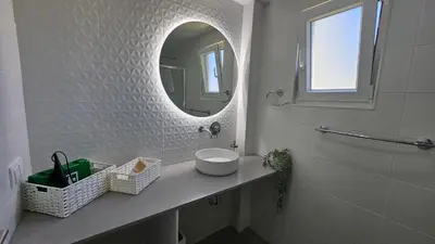 a white bathroom with a sink and a mirror at Ocean View Beach Studio Old Town in Albufeira