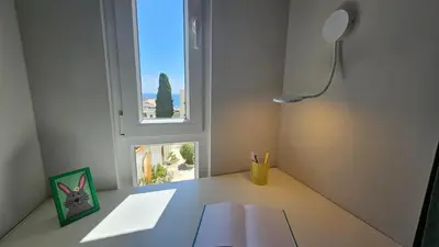 a white room with a desk with a window at Ocean View Beach Studio Old Town in Albufeira