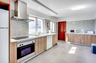 a kitchen with a sink and a stove at Villa Crispa in Albufeira