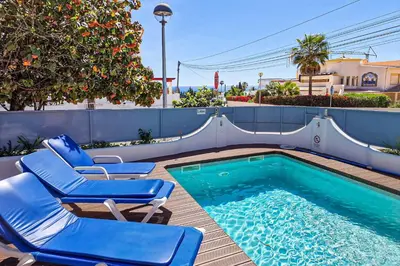 a pool with chairs and a water slide at Villa Crispa in Albufeira