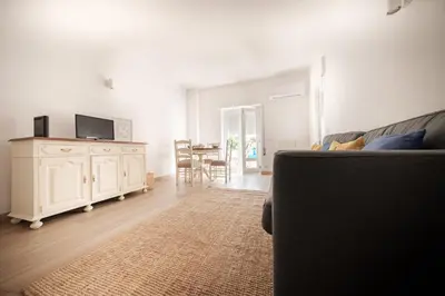 a living room with a couch and a table at Sunny Days beach apartment in Quarteira