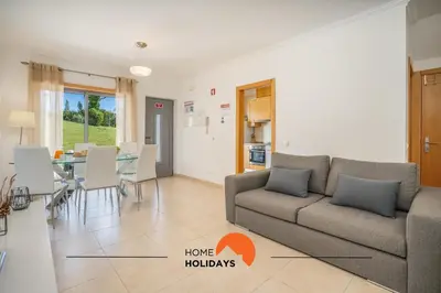 a living room with a couch and a table at #154 V2 Vila Branca 54 by Home Holidays in Albufeira