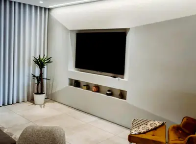 a living room with a flat screen tv on the wall at Sunlight Albufeira by Sunnyway in Albufeira