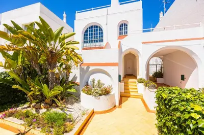 a villa with a swimming pool and a house at Villa Lili in Albufeira