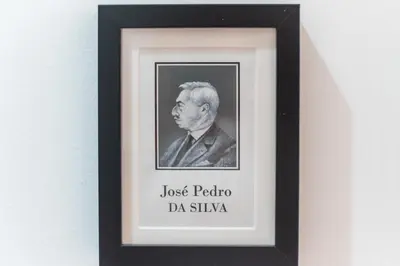 a framed picture of a man in a suit at Privilege Apartment Aliança da Silva in the heart of Faro in Faro