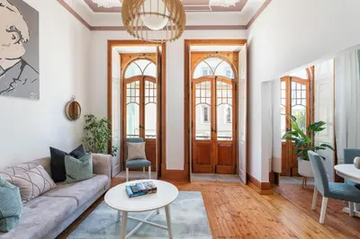a living room with a couch and a table at Privilege Apartment Aliança da Silva in the heart of Faro in Faro