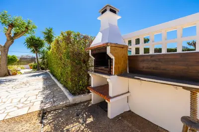 a building with a chimney on the side of it at Villa Brejos in Albufeira