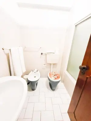 a bathroom with a toilet and a bidet at T1 Largo Frente - Familiar in Quarteira