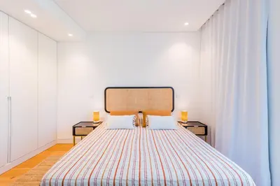 a bedroom with a large bed with two night stands at Lakes 24 at Praia da Falesia Vilamoura in Vilamoura