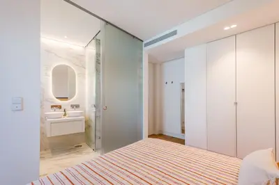a bedroom with a glass shower and a sink at Lakes 24 at Praia da Falesia Vilamoura in Vilamoura