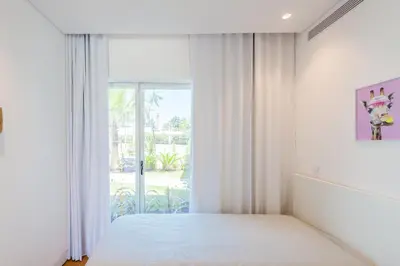 a bedroom with a bed and a large window at Lakes 24 at Praia da Falesia Vilamoura in Vilamoura