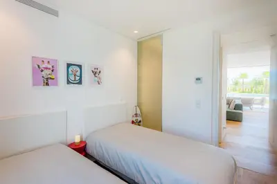 a bedroom with two beds and a living room at Lakes 24 at Praia da Falesia Vilamoura in Vilamoura