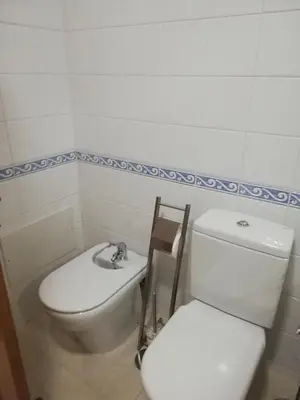 a bathroom with a toilet and a sink at Villa V2 V in Olhos de Água