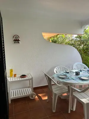 a white table with chairs and a table with glasses on it at Solar dos Pinheiros in Vilamoura