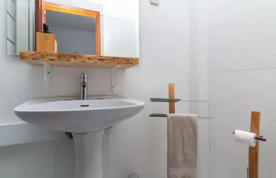 a white bathroom with a sink and a mirror at Old Town Apartment Panoramic NearThe Beach in Albufeira